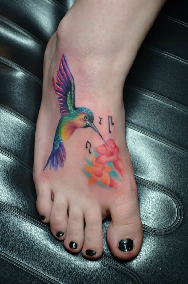 tattoo-kolibri-Colorful-Hummingbird-With-Flowers-And-Music-Knots-Tattoo-On-Girl-Foot-resized