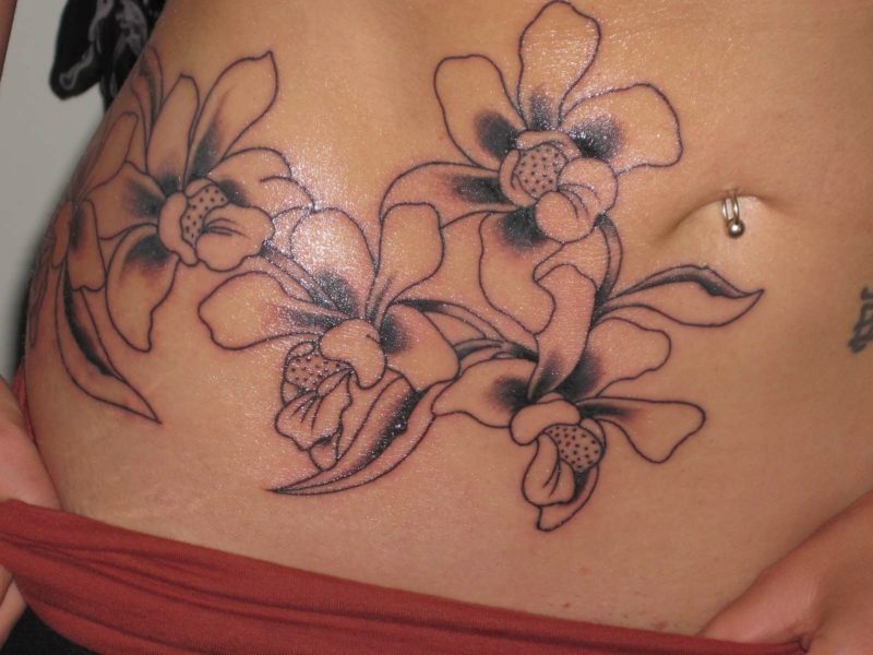 orchideen tattoo grey ink on lowerback